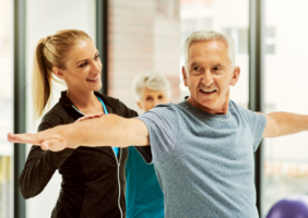 Elderly Man with fitness instructor