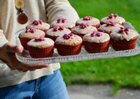 Woman Holding Cup Cakes on a Tray