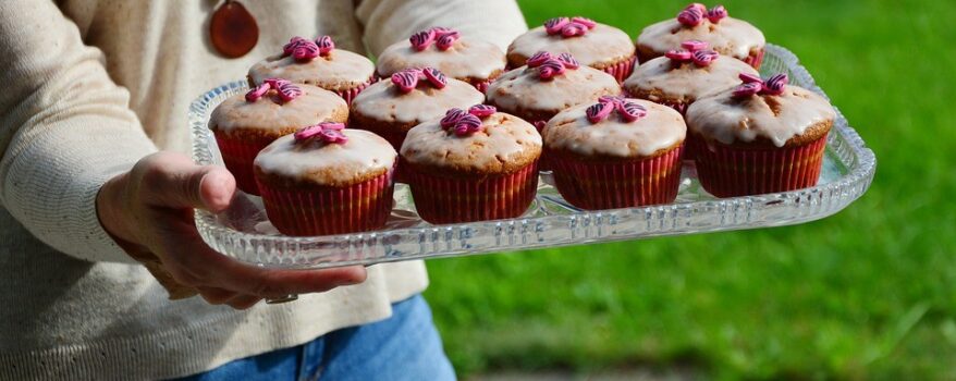 Woman Holding Cup Cakes on a Tray