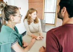 2 women and 1 man talking