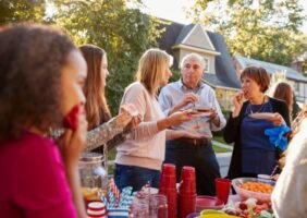 Neighbours sharing food together on the street