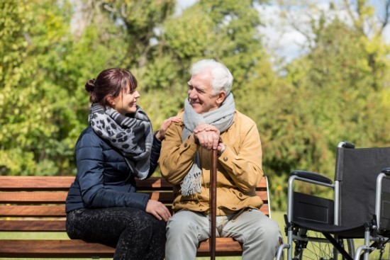 Caring for elderly man in the park