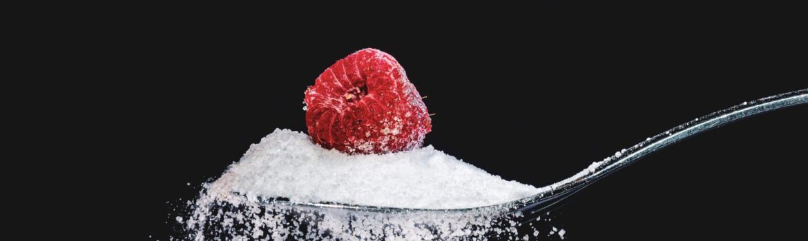 Raspberry sitting in sugar