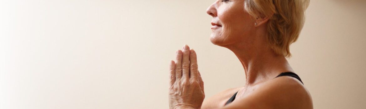 Elderly woman practising yoga