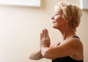 Elderly woman practising yoga