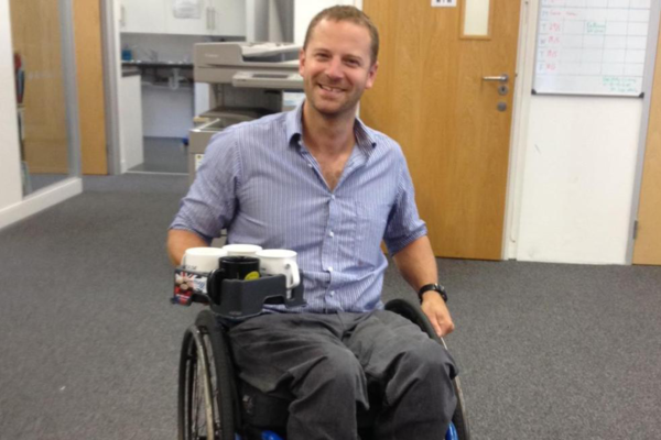 Wheelchair User using the Muggi Cup Holder