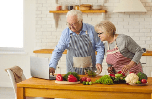 Elderly couple cooking in the kitchen