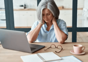 Woman with neck pain at work - fibromyalgia