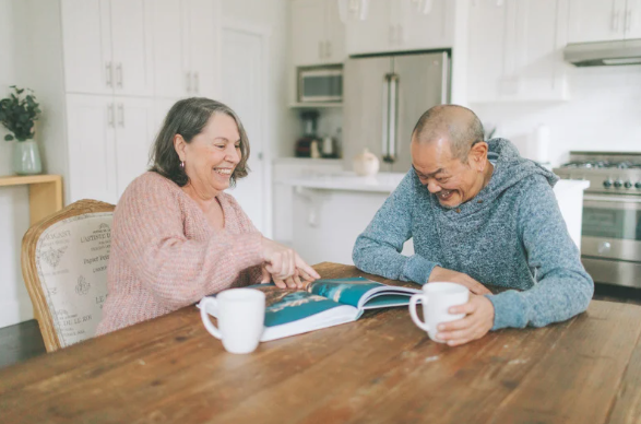 Elderly couple enjoying a cup of tea in the kitchen