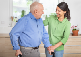 A carer helping an elderly man