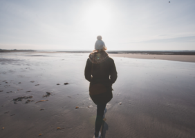 Woman walking on the beach at winter