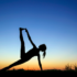 Woman doing yoga at sunrise