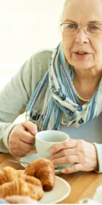 Daughter talking to her elderly mother over tea