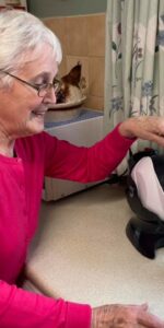 Elderly woman making tea with her tilt-to-pour Uccello Kettle