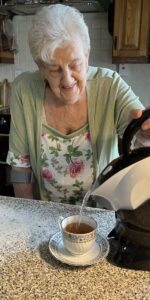 Elderly woman making herself a cup of tea with the Uccello Kettle