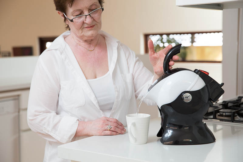 Elderly Woman using the Uccello Kettle to make tea